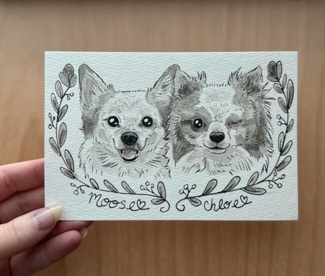 Hand-drawn illustration of two dogs with names 'Moose' and 'Chloe' on a card held by a hand.