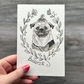 Hand holding a card with a pug illustration and 'Butters' text against a gray background