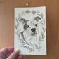 Hand-drawn card with a watercolor dog illustration and 'Junebug' text on a wooden surface.