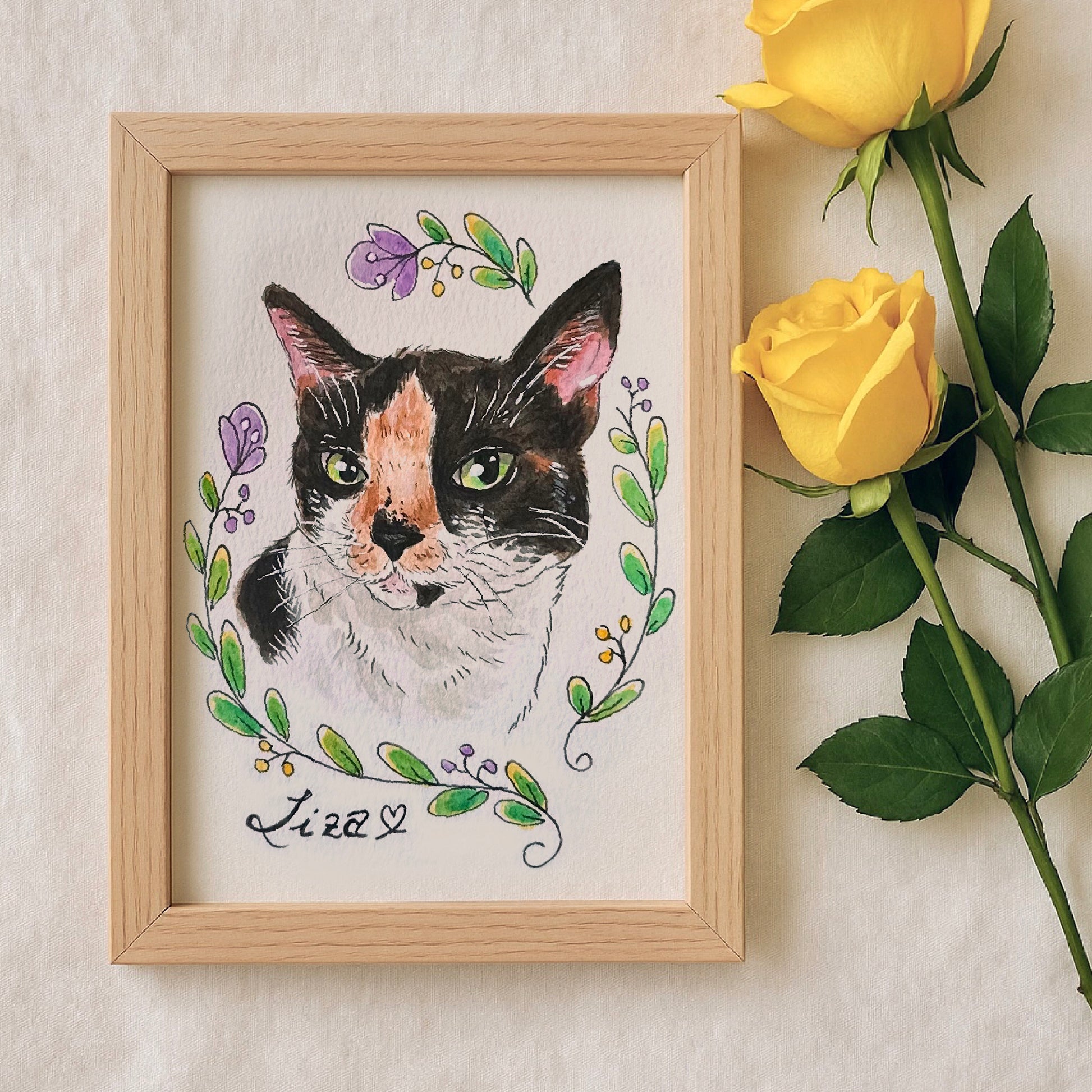 Framed watercolor illustration of a cat with floral elements and yellow roses on a light background